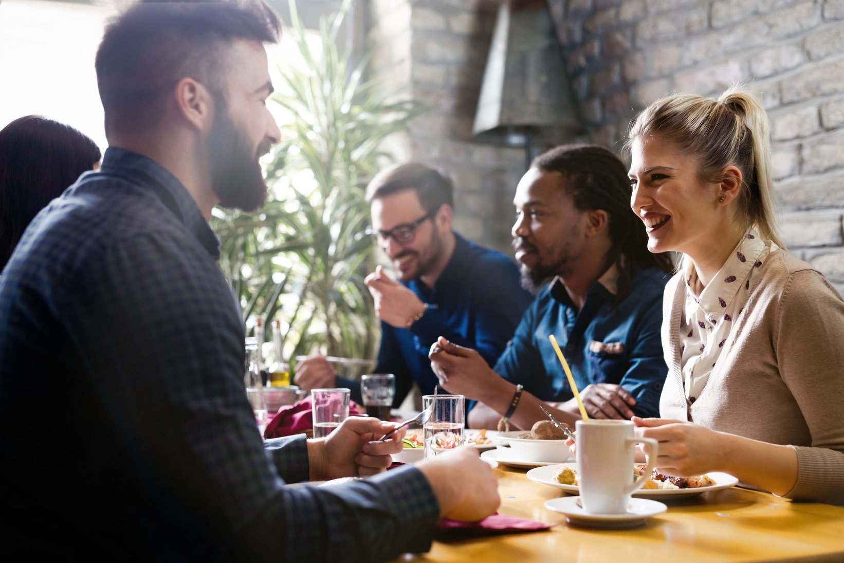 Happy young friends hangout in coffee shop